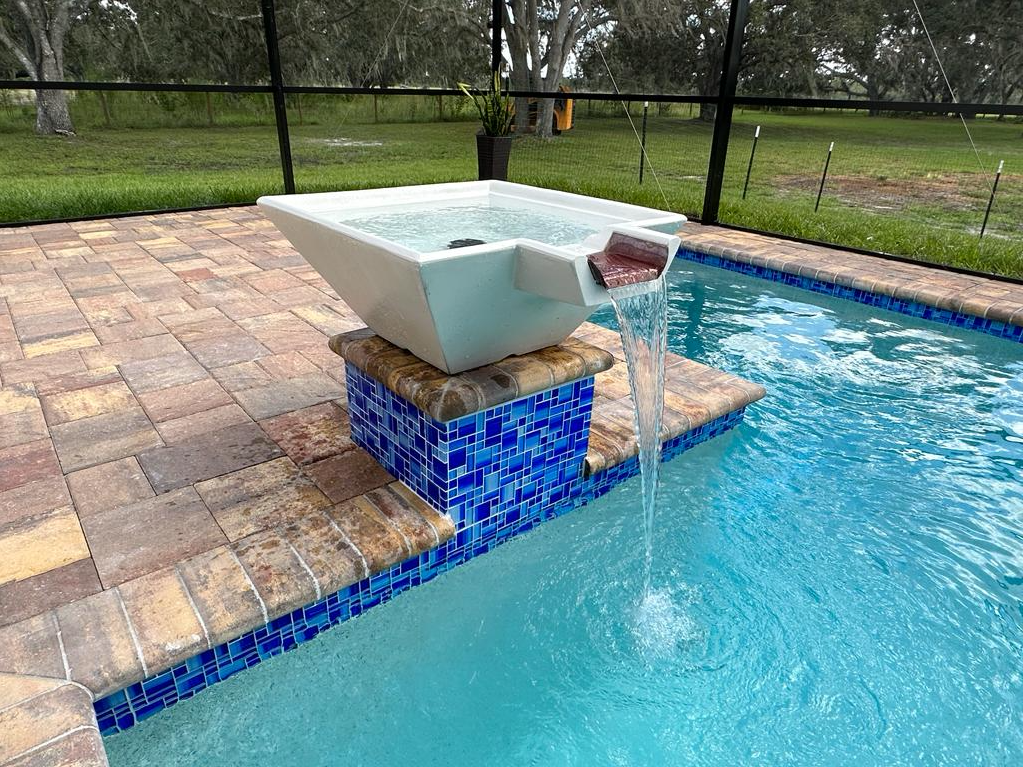 There is a waterfall in the middle of the pool.