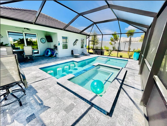 A large swimming pool in the backyard of a house
