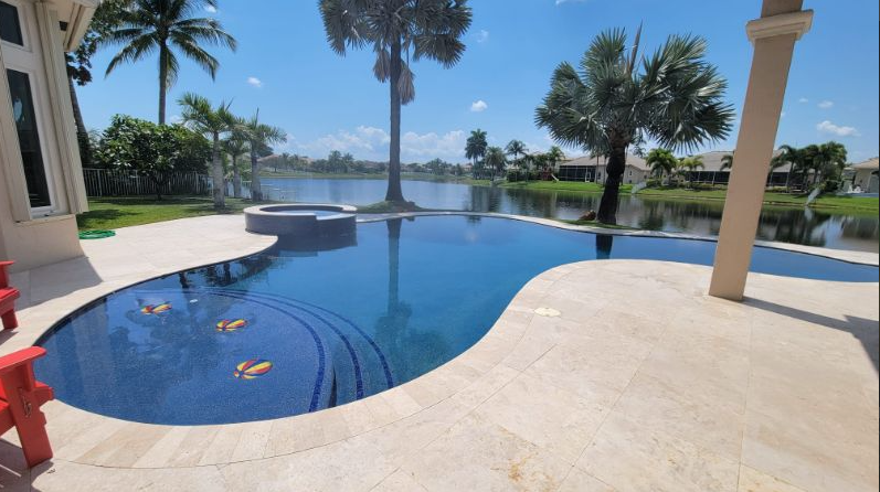 A large swimming pool with palm trees in the background