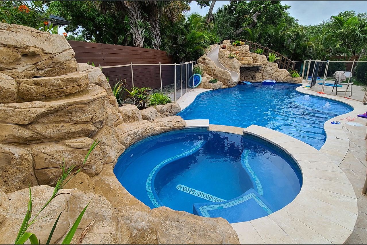 A large swimming pool with a hot tub in the middle of it