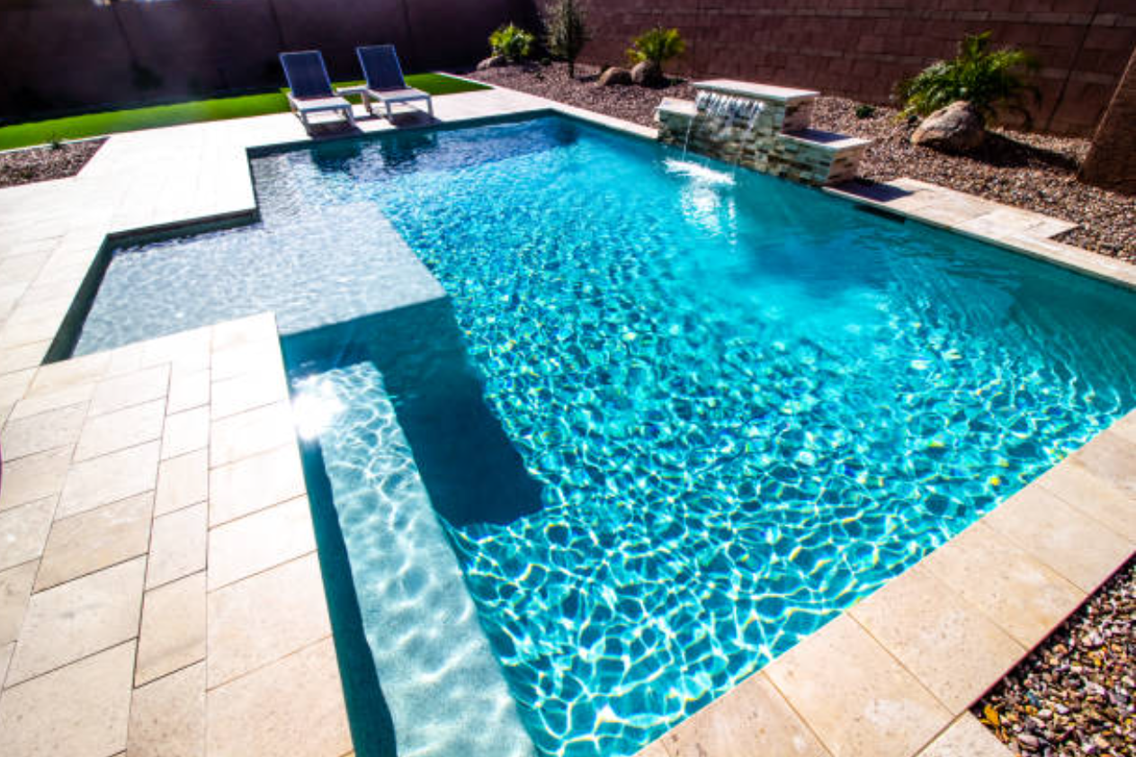 A large swimming pool with stairs leading to it
