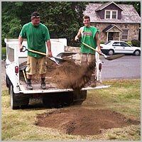 Filling the hole with fresh topsoil - Tree Service in Ellwood City, PA
