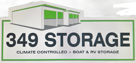 Logo for 349 Storage. White building with green trim. Text: 349 STORAGE, Climate Controlled + Boat & RV Storage.
