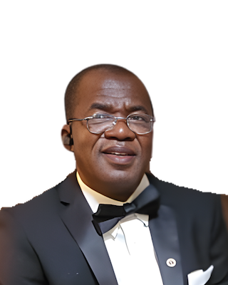 Man in formal attire, glasses, and bow tie, indoors.