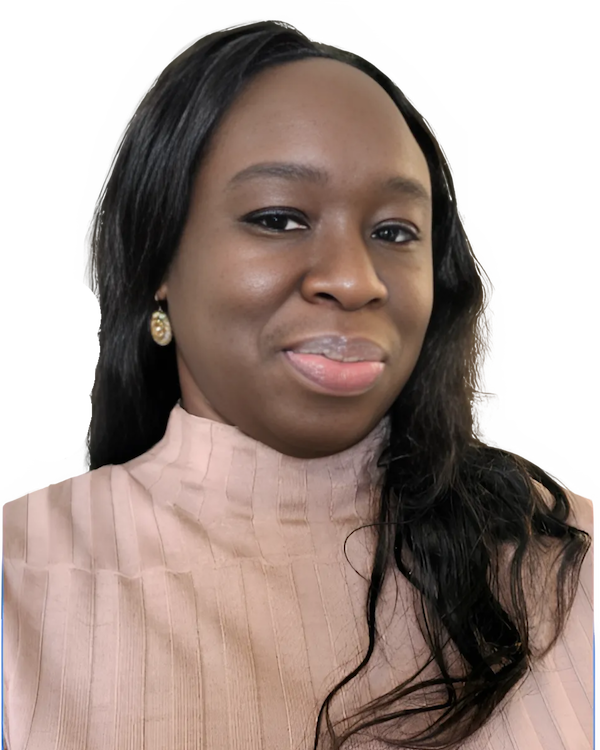 A woman wearing a pink sweater and gold earrings smiles for the camera