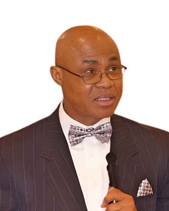 Man in pinstripe suit, bow tie, and glasses, holding a microphone.