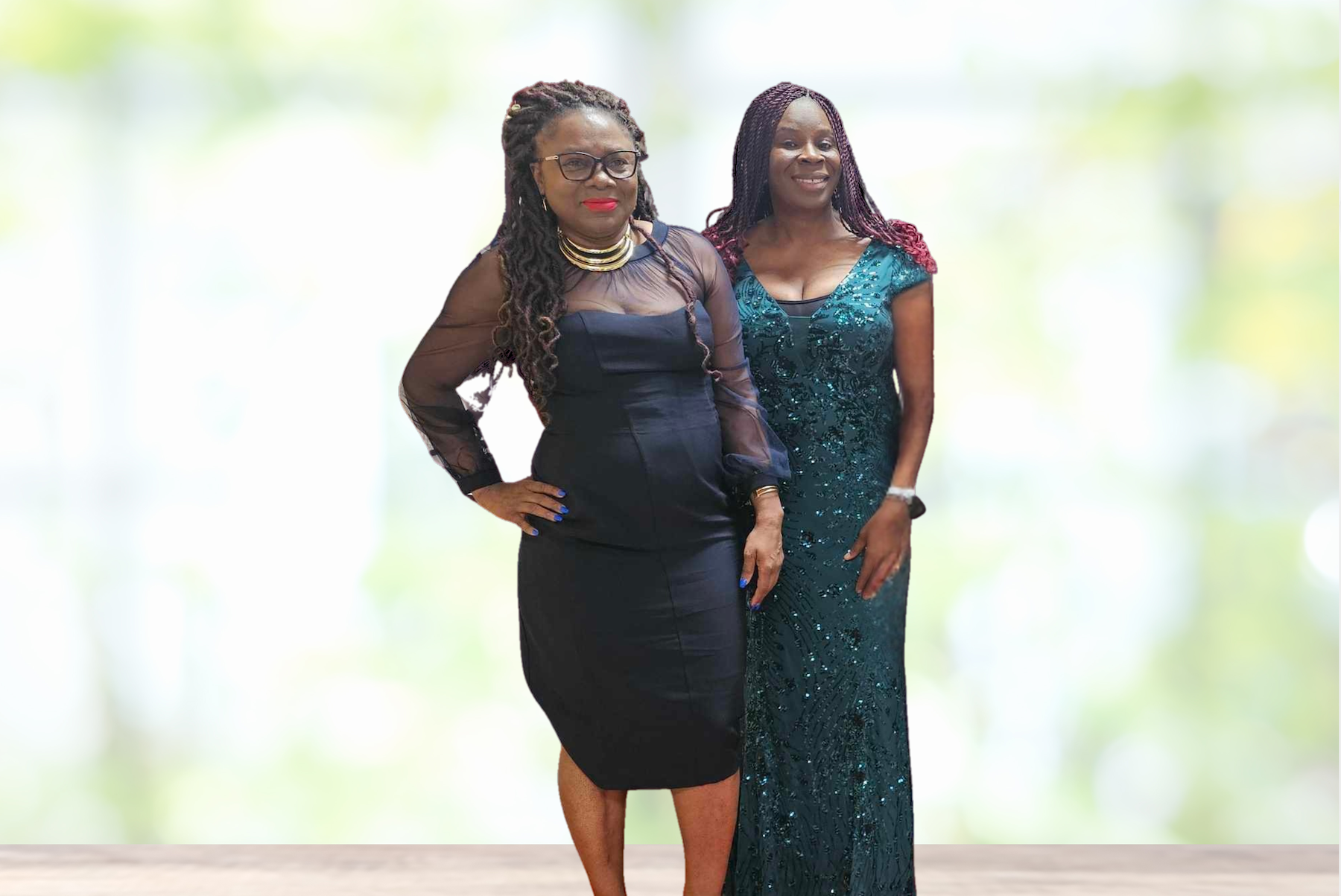 Two women in dresses are standing next to each other.