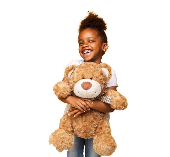 Girl with dark skin happily hugging a brown teddy bear against a white background.
