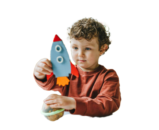 Young child holding a blue and red rocket and a planet toy; white background.