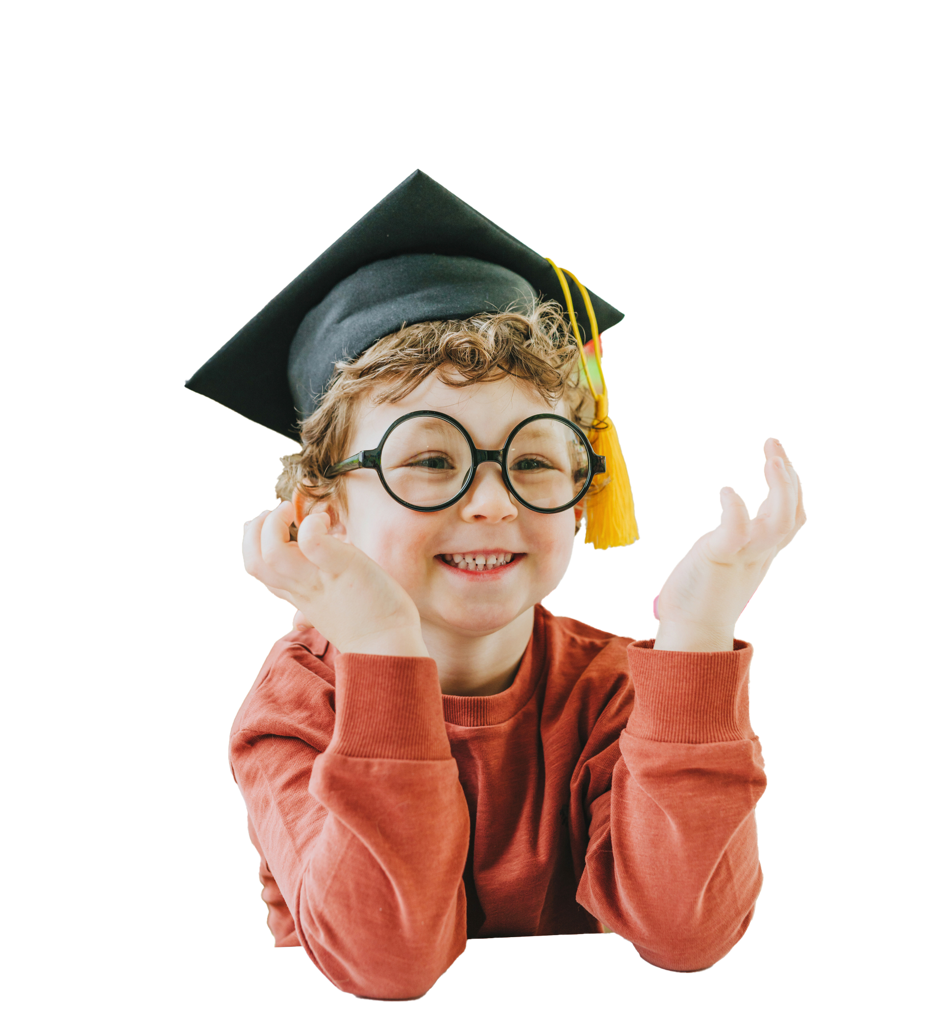 Boy with glasses resting arms on a surface, smiling and looking upward.