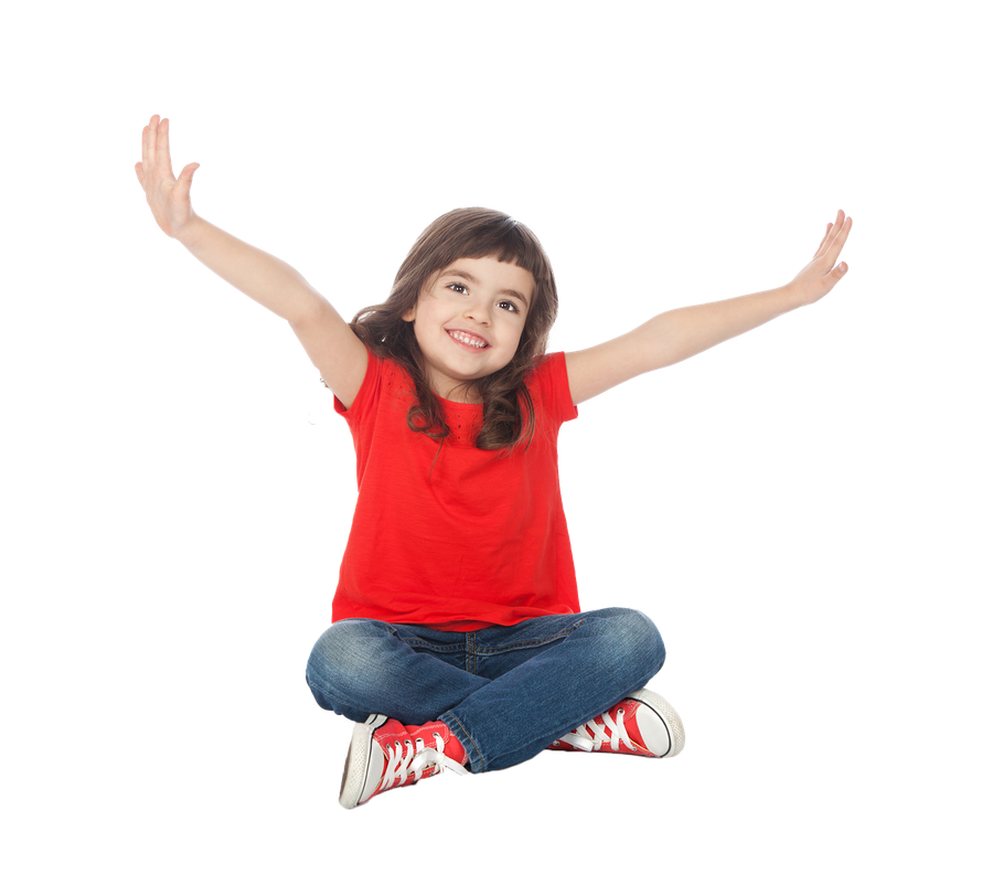 Girl in red shirt and jeans sits cross-legged with arms outstretched, smiling.