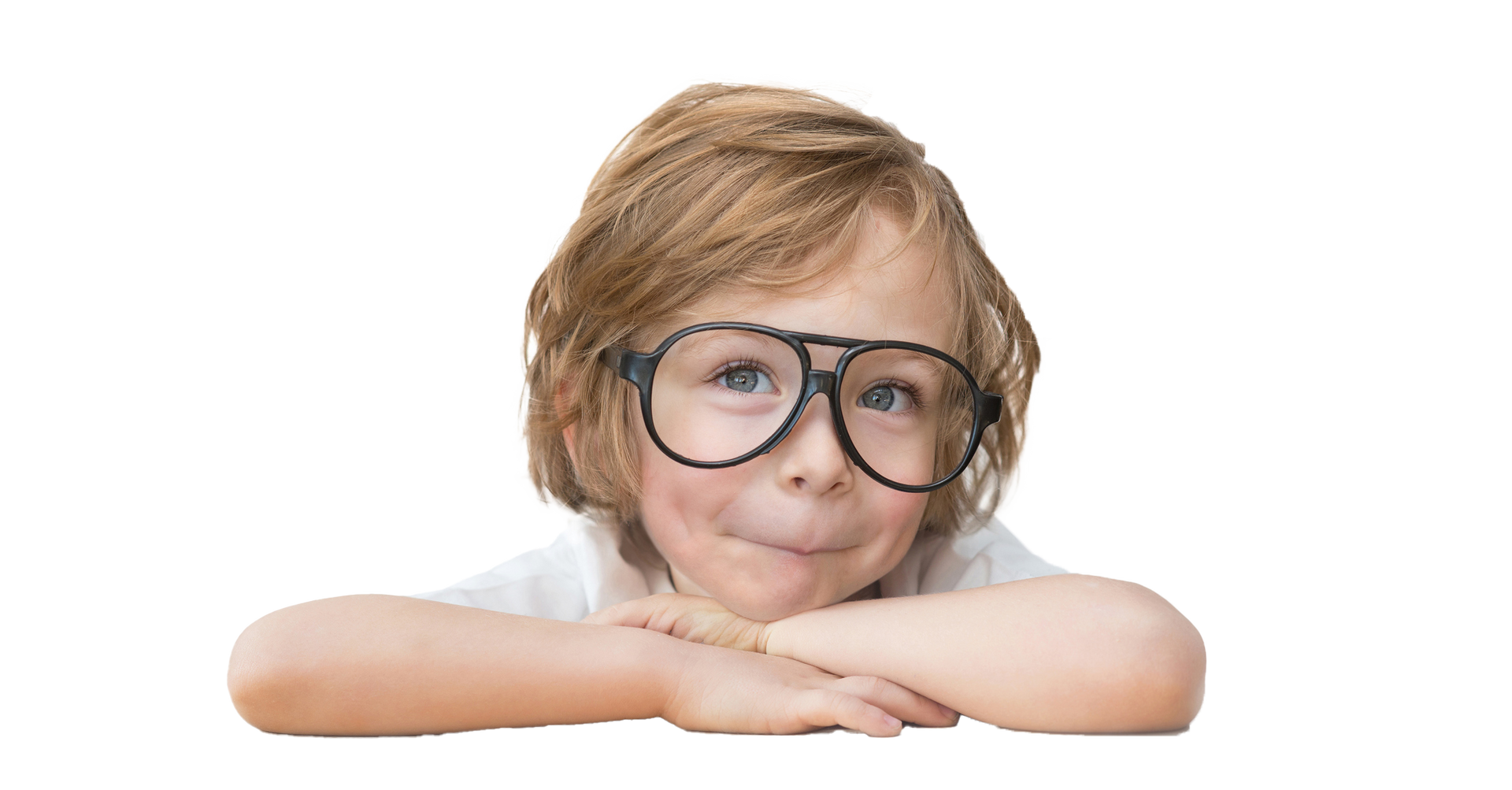 Boy with glasses resting arms on a surface, smiling and looking upward.
