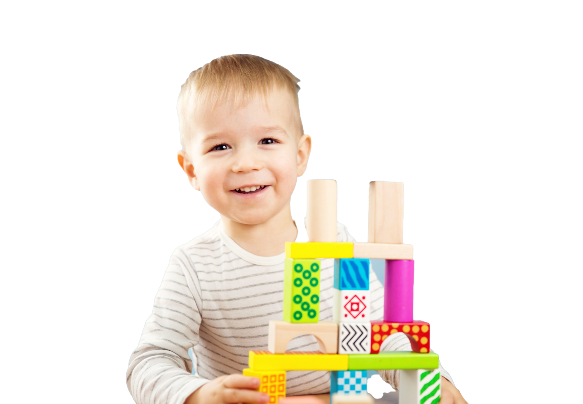 Smiling child building with colorful wooden blocks.