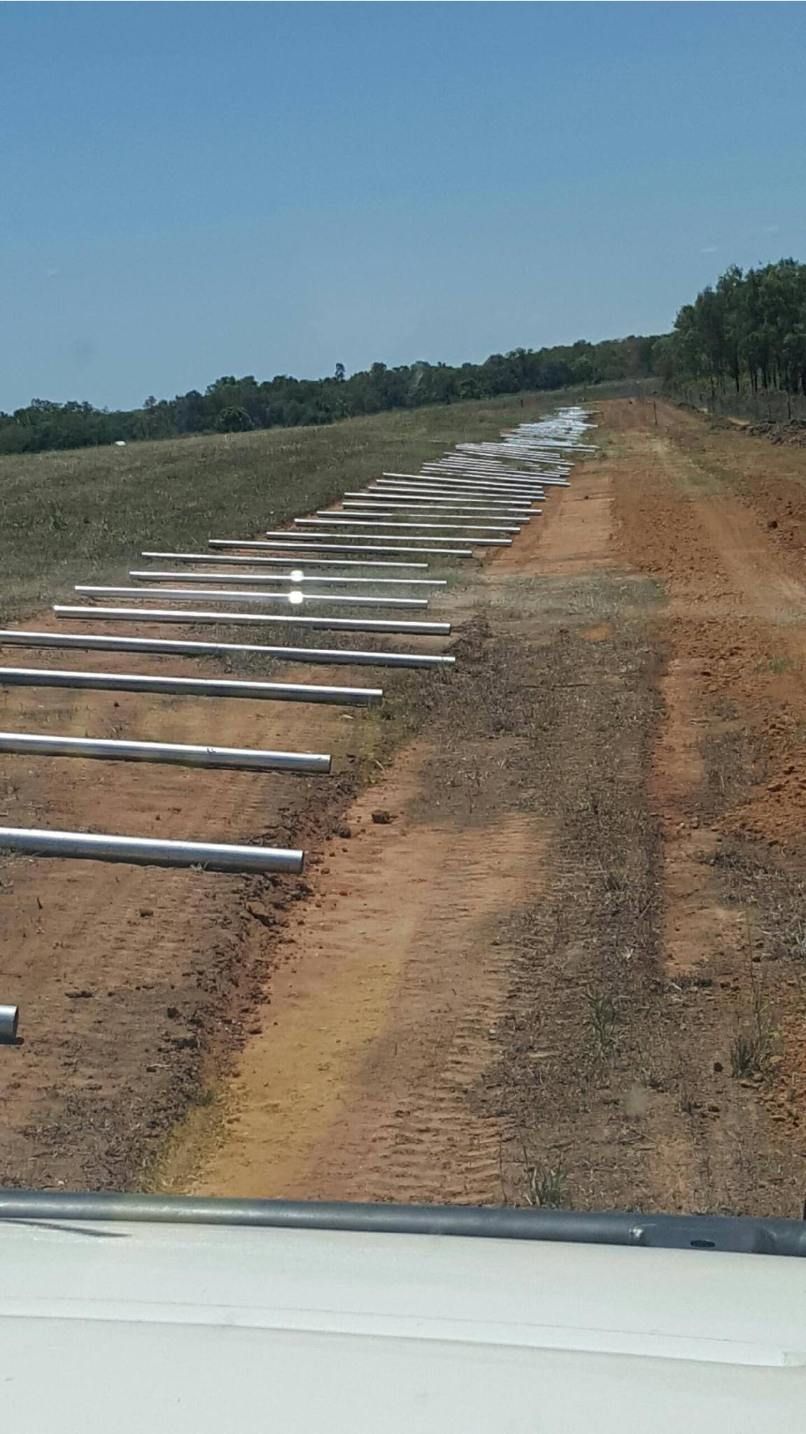 A Dirt Road With A Row Of Metal Poles On The Side Of It — Territory Industries Pty Ltd In Uralla, NT