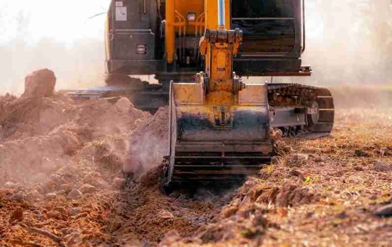 A Bulldozer Is Moving Dirt In A Field — Territory Industries Pty Ltd In Uralla, NT