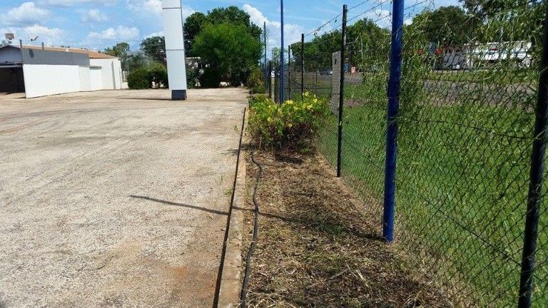 A Chain Link Fence Is Surrounding A Dirt Road — Territory Industries Pty Ltd In Katherine, NT
