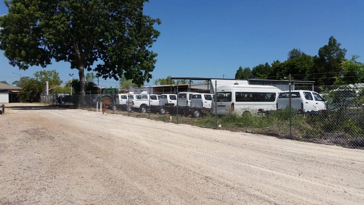 A Row Of White Vans Are Parked On The Side Of A Dirt Road — Territory Industries Pty Ltd In Uralla, NT