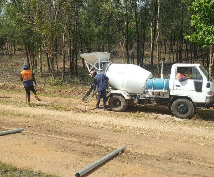 A Concrete Mixer Truck Is Driving Down A Dirt Road — Territory Industries Pty Ltd In Uralla, NT