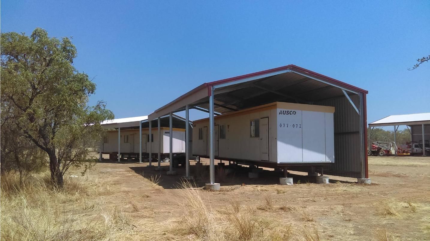 A Row Of Trailers Are Parked Under A Shed In A Field — Territory Industries Pty Ltd In Timber Creek, NT