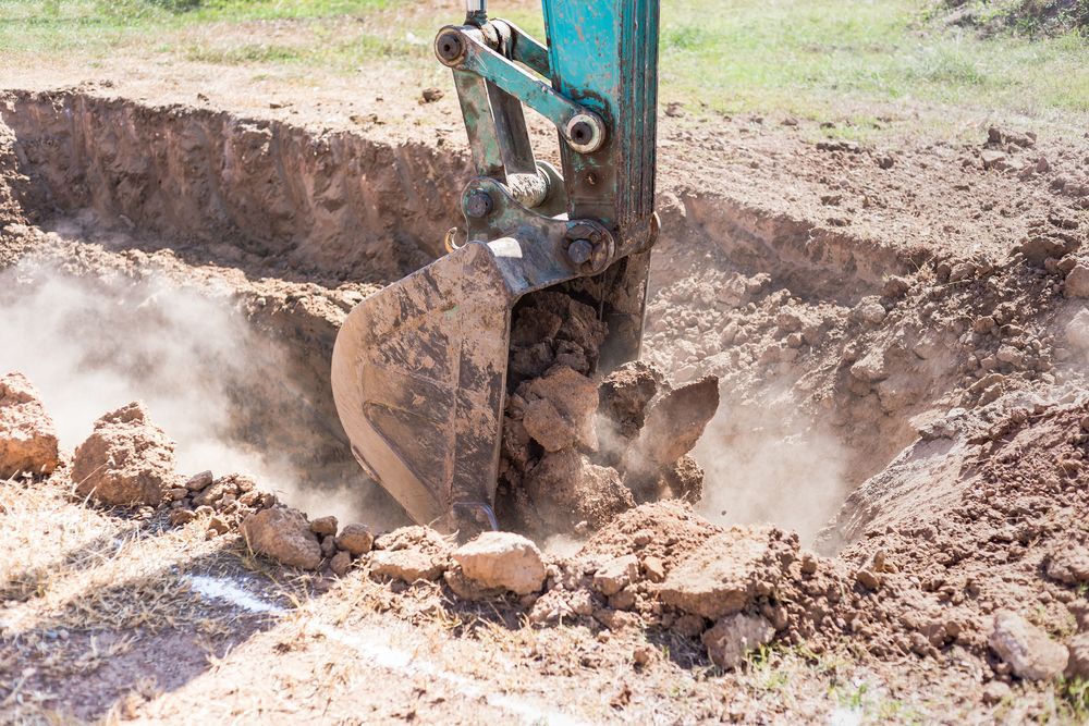 A Bulldozer Is Digging A Hole In The Ground — Territory Industries Pty Ltd In Katherine, NT