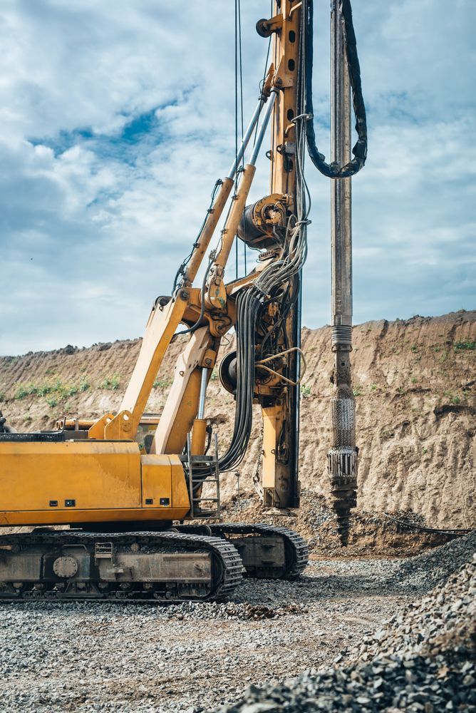 A Yellow Excavator Is Working On A Construction Site — Territory Industries Pty Ltd In Uralla, NT