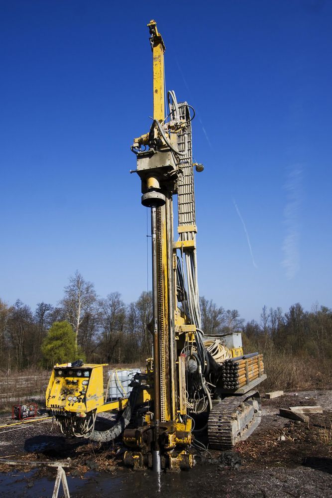 A Large Yellow Machine Is Drilling A Hole In The Ground — Territory Industries Pty Ltd In Larrimah, NT