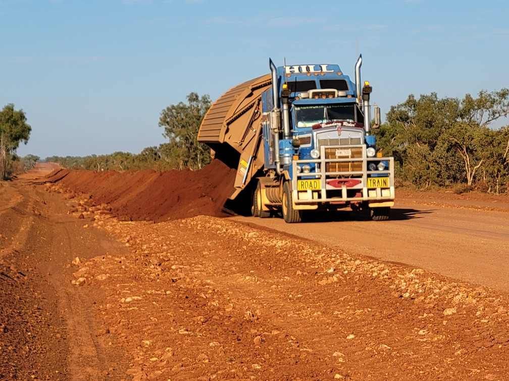 Truck unloading dirt for road — Territory Industries Pty Ltd In Uralla, NT