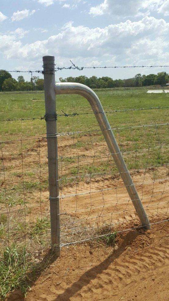 A Barbed Wire Fence With A Broken Post In The Middle Of A Field — Territory Industries Pty Ltd In Uralla, NT