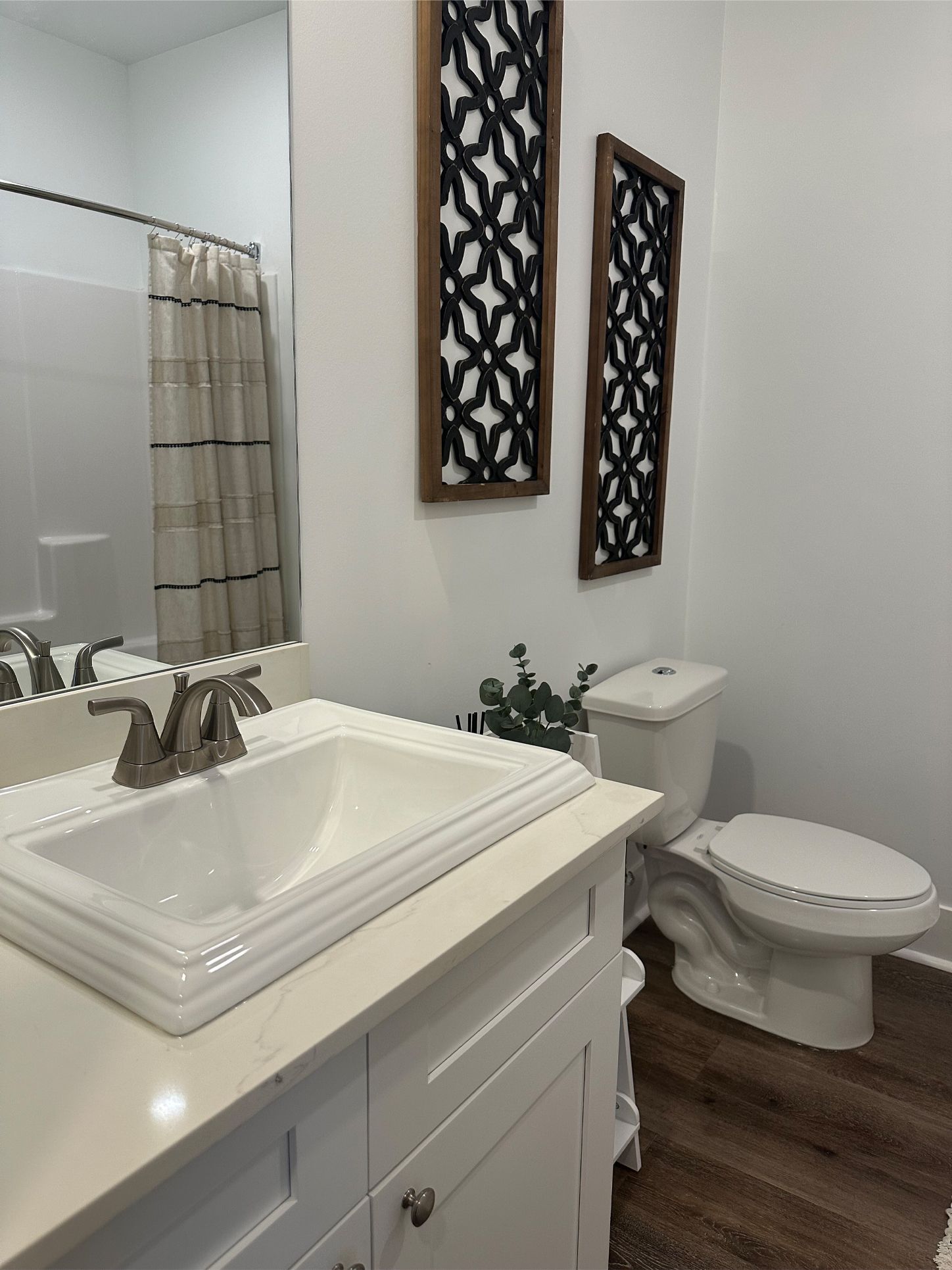 A bathroom with a sink , toilet and mirror