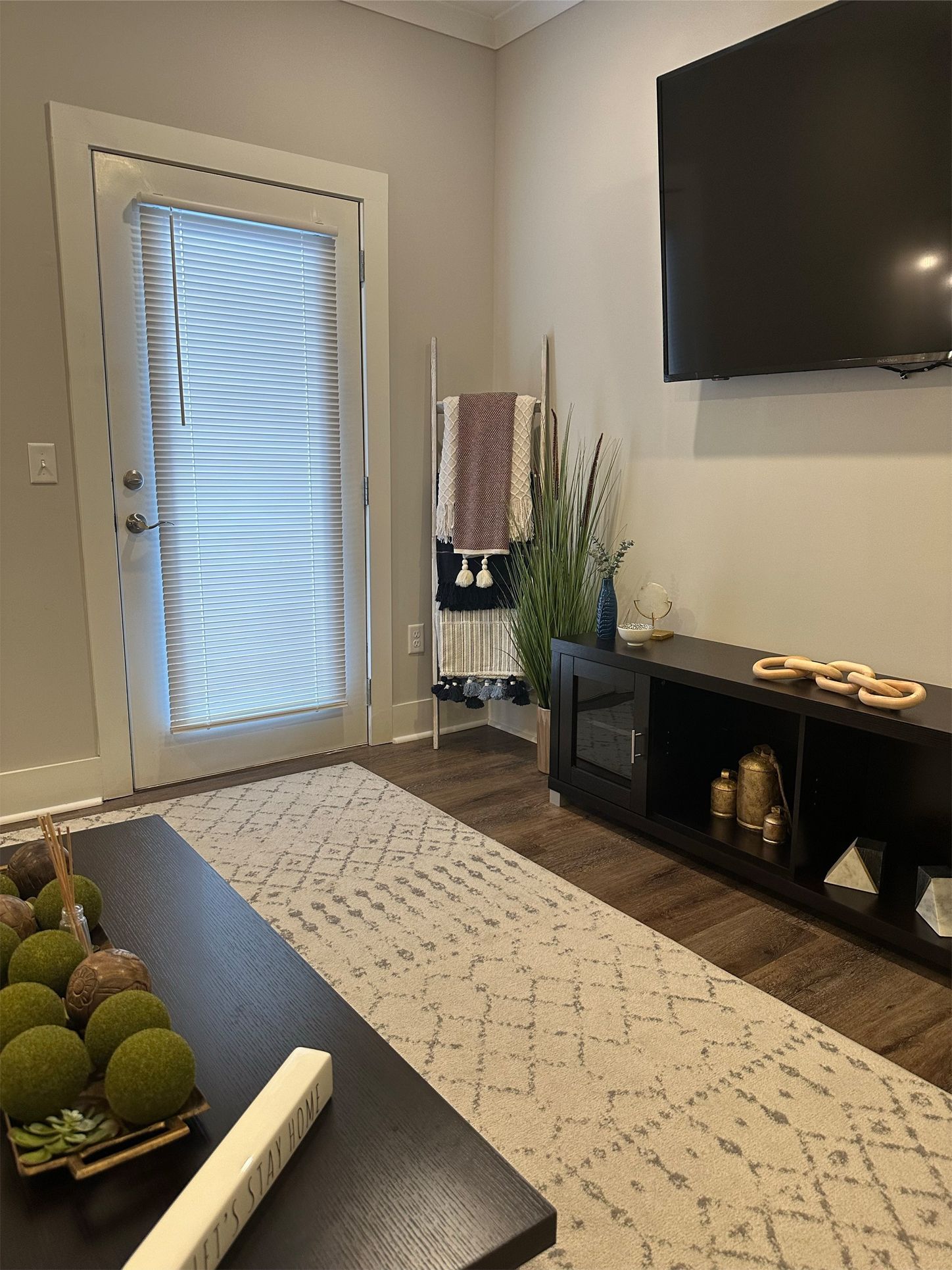 A living room with a sliding glass door and a flat screen tv.