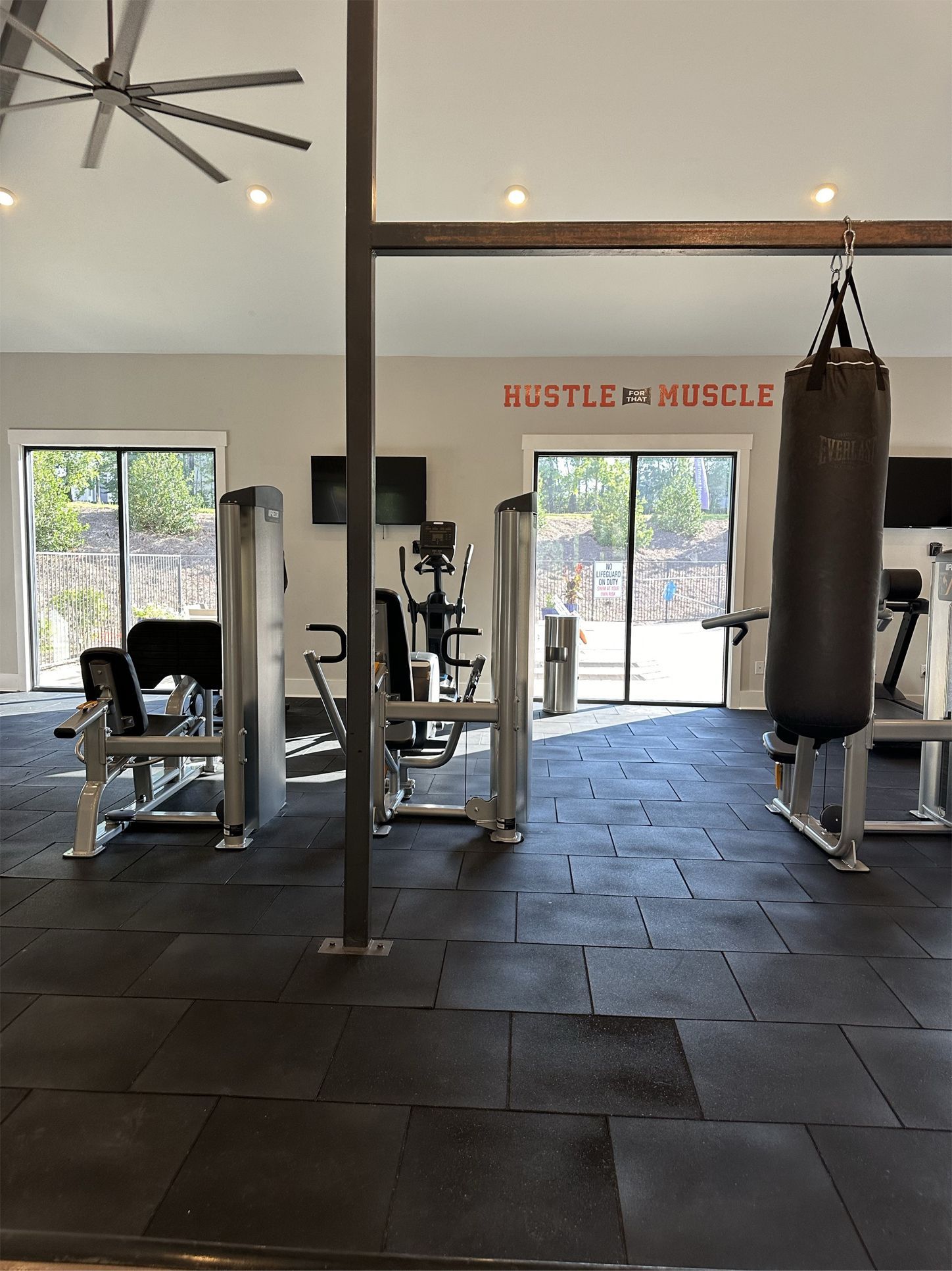 A gym with a sign that says hustle & muscle