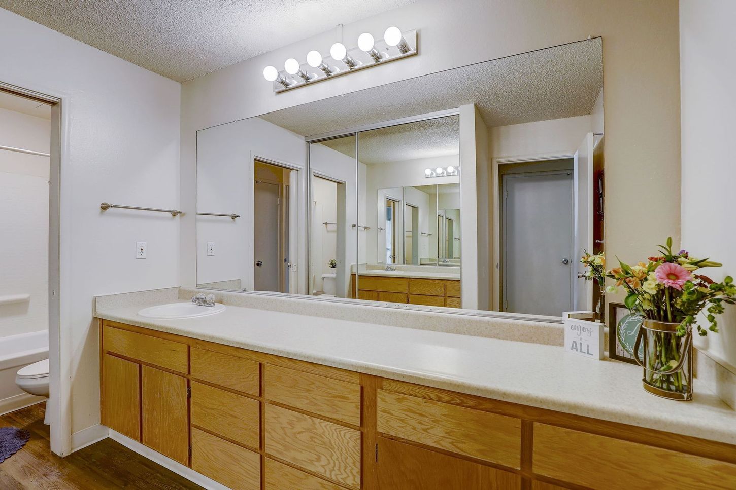 A bathroom with two sinks and a large mirror.