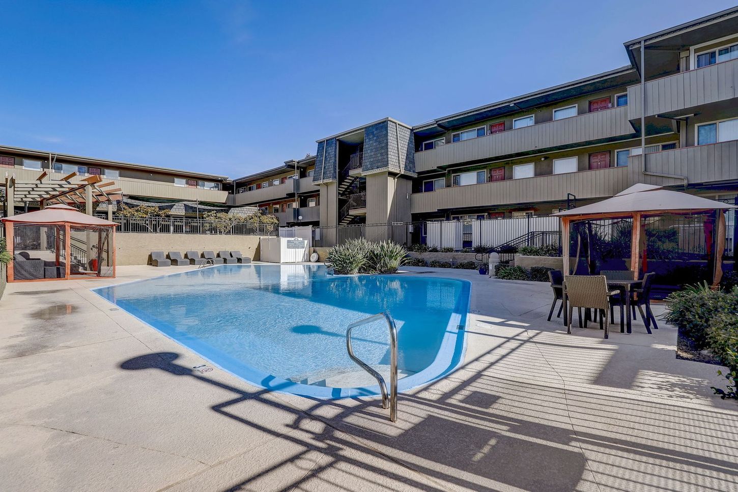 A large swimming pool is in the middle of a large building.