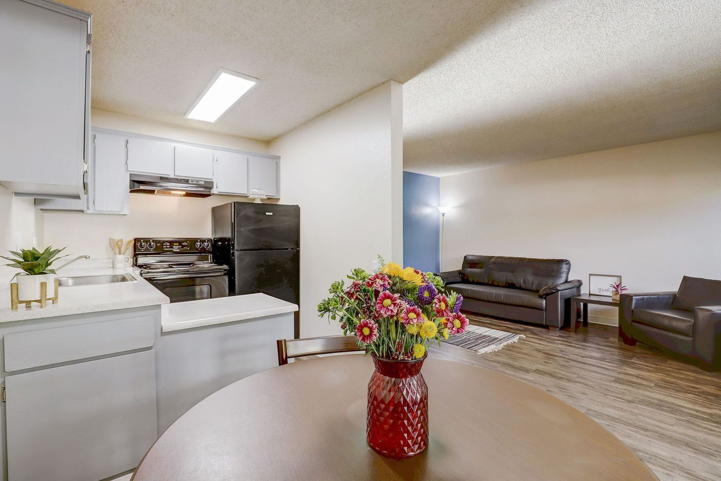 There is a vase of flowers on the table in the living room.