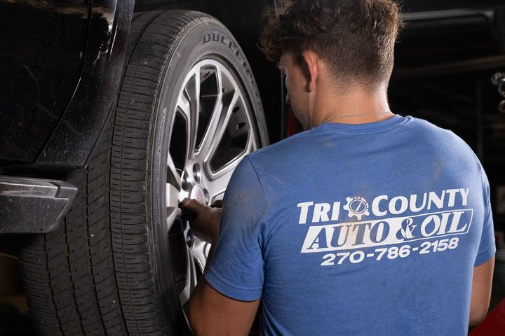 A service mechanic is working on a tire.