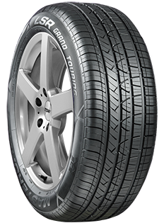 A close up of a tire on a car wheel on a white background.