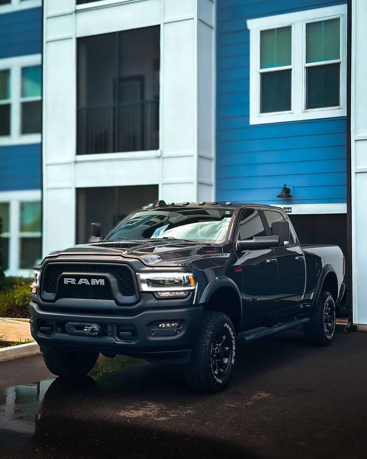 lifted RAM Power Wagon with a 3-year ceramic coating and paint enhancement parked outside of a large blue apartment building
