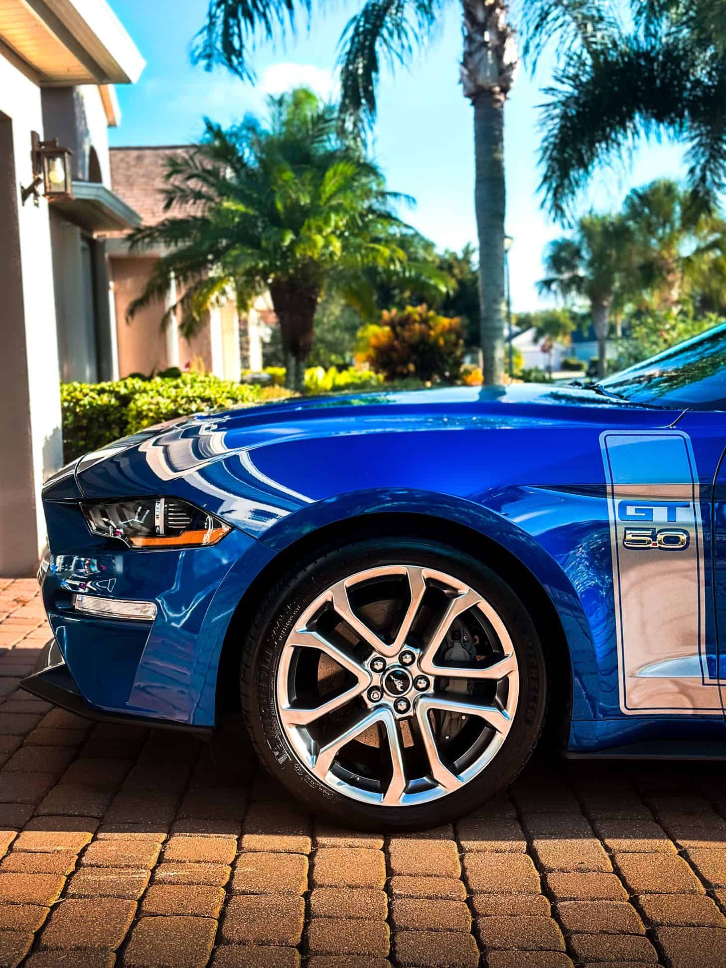 a Blue 2017 Ford Mustang GT California 5.0 and custom vinyl GT stickers, and front lip in Viera, FL