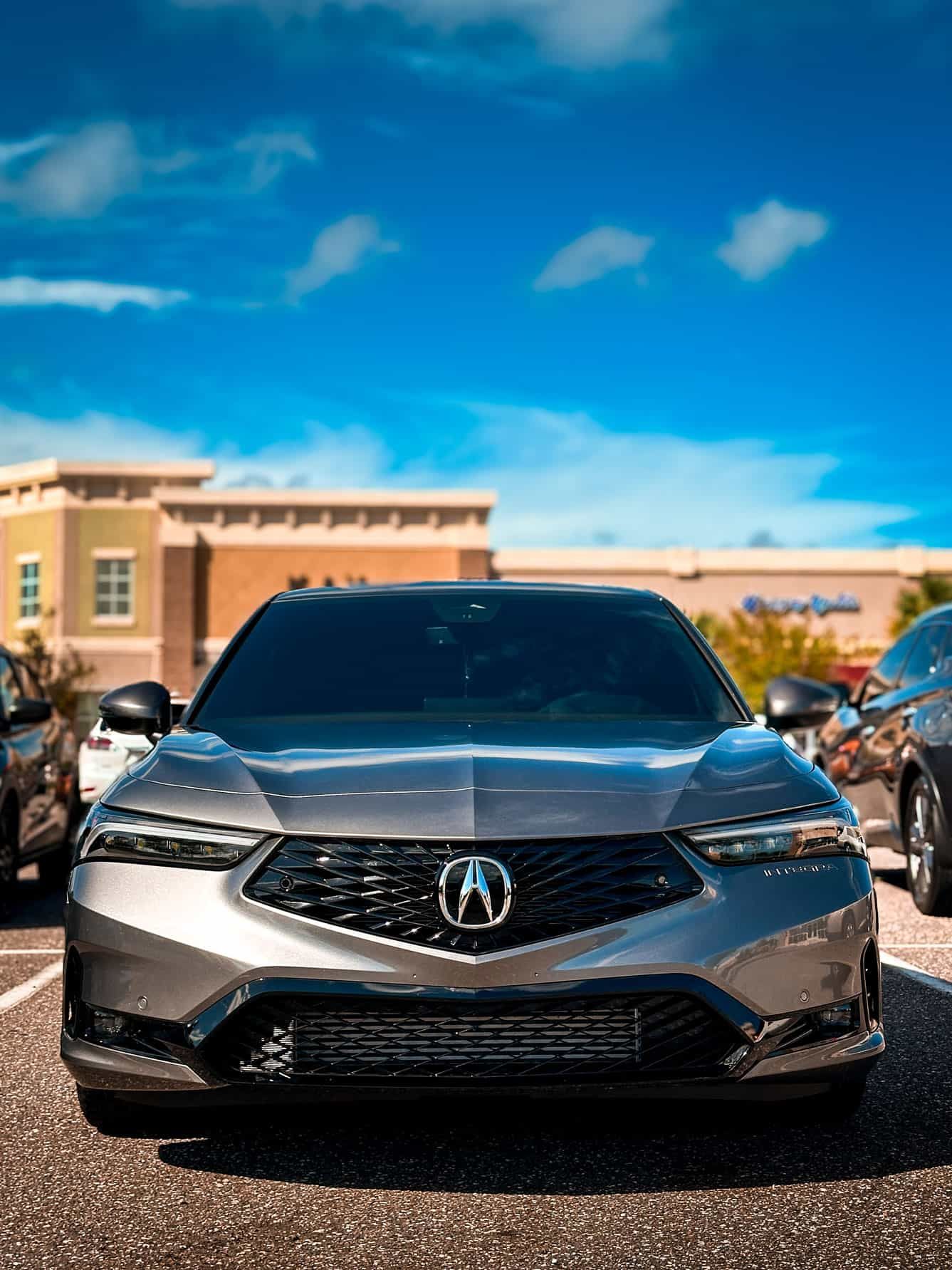 a lowered 2024 Grey Acura Integra in a busy parking lot in Palm Bay, FL