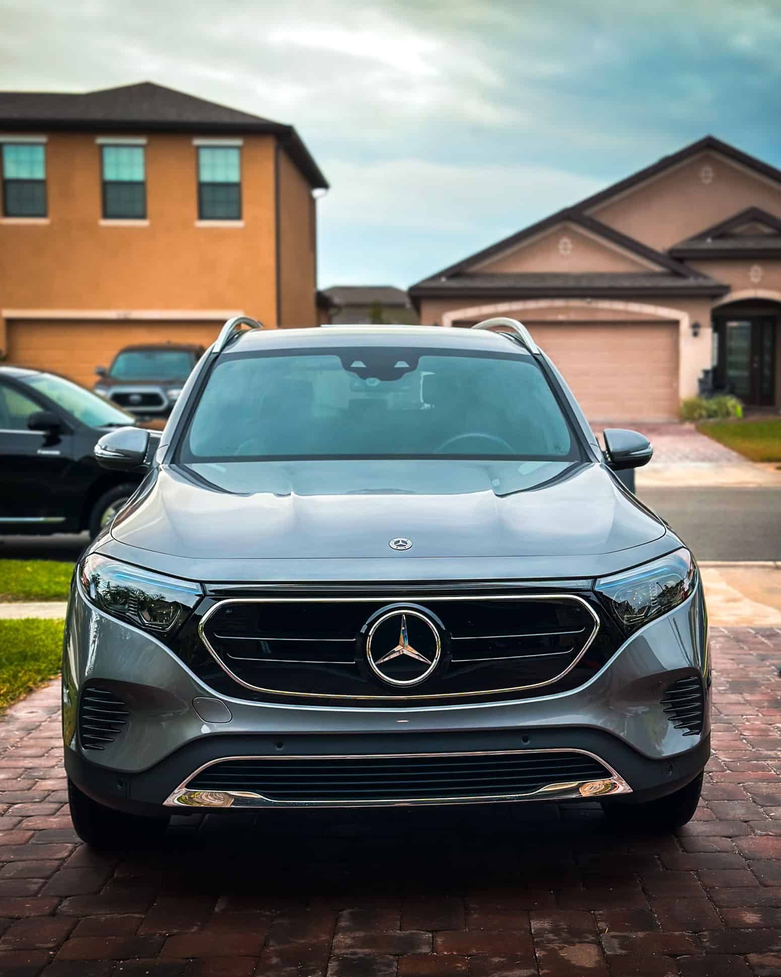 a ceramic coated Grey 2025 Mercedes EQB 300 in front of an orange house in West Melbourne, FL
