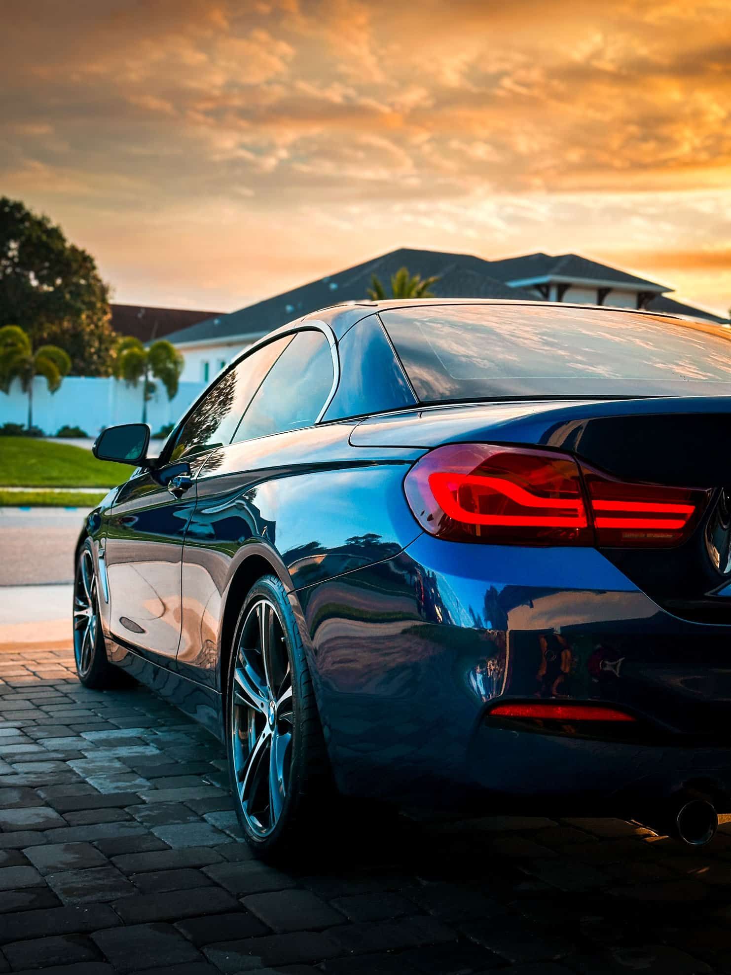 custom Blue BMW m440i rear quarter panel on the drivers side during sunset in Merritt Island, FL