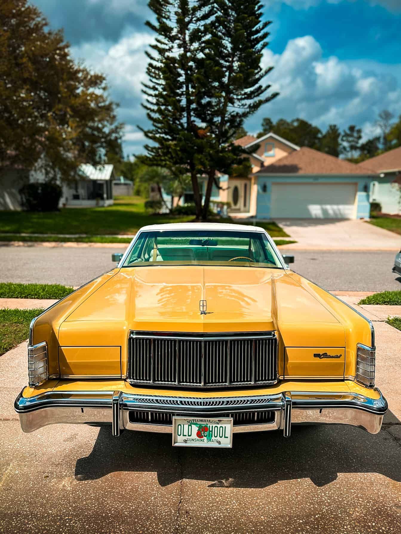 a Ceramic Coated 1973 Yellow Lincoln Town Car with high gloss finish