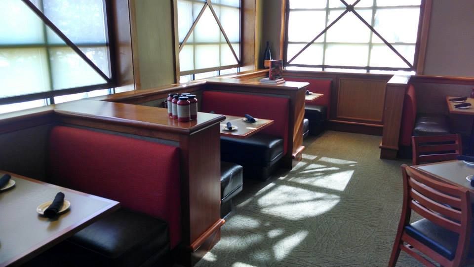 A restaurant with tables and booths and a lot of windows