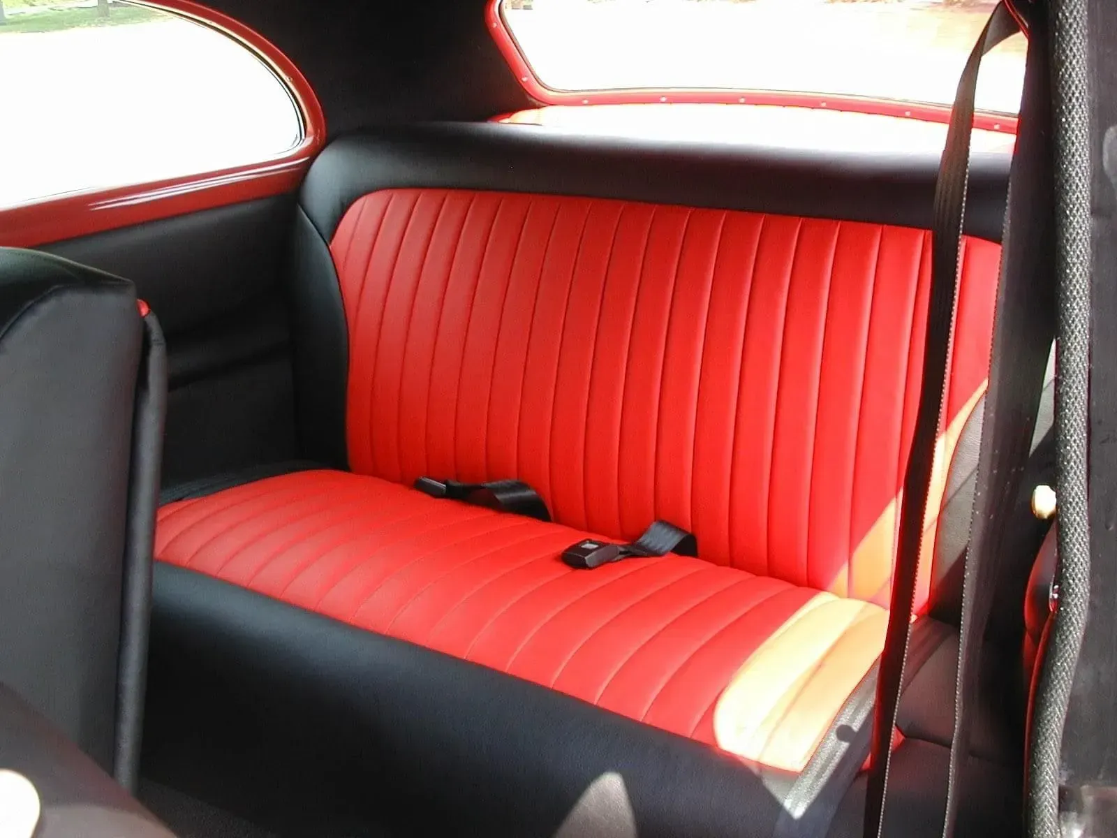 The back seat of a car is red and black