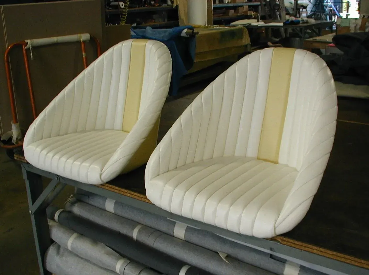 Two white chairs with yellow stripes are sitting on a table