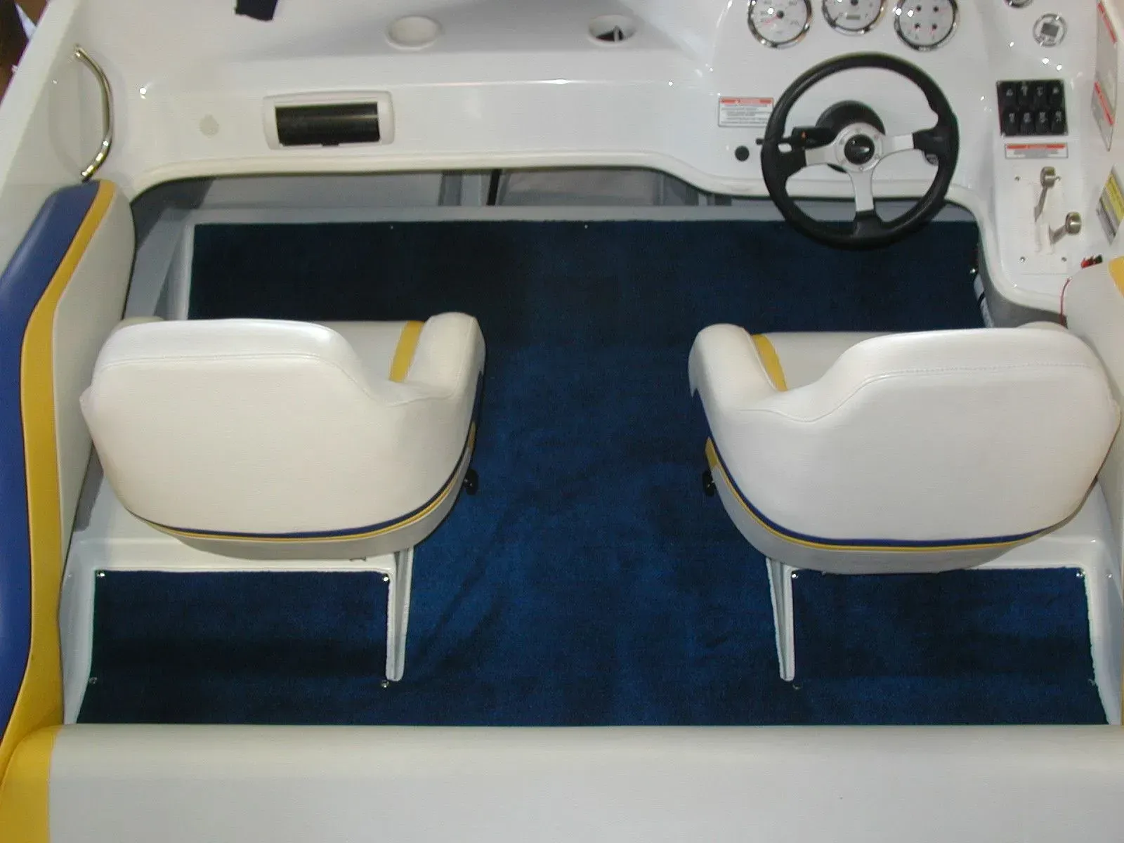 A boat with two seats and a steering wheel