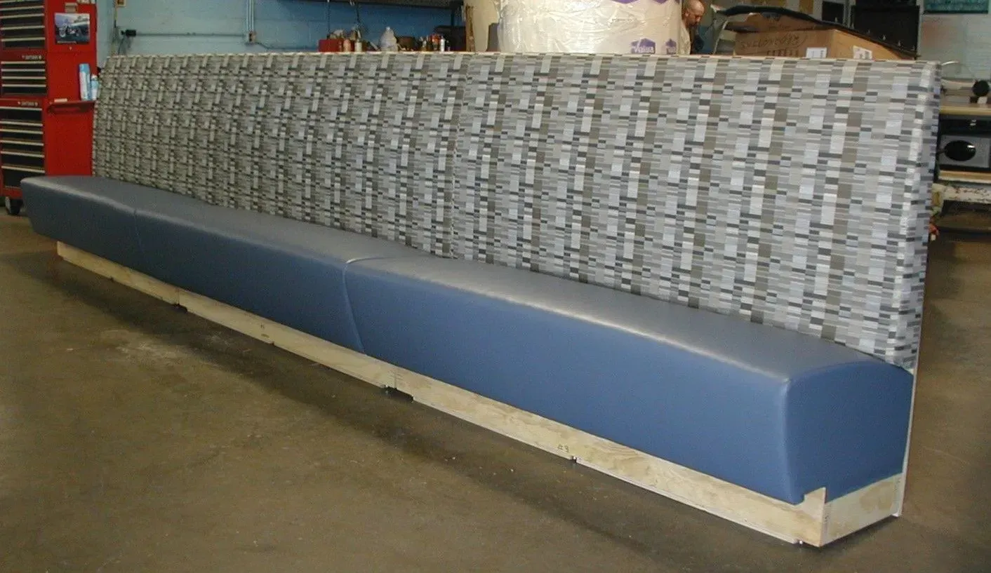 A long blue bench with a gray pattern on it