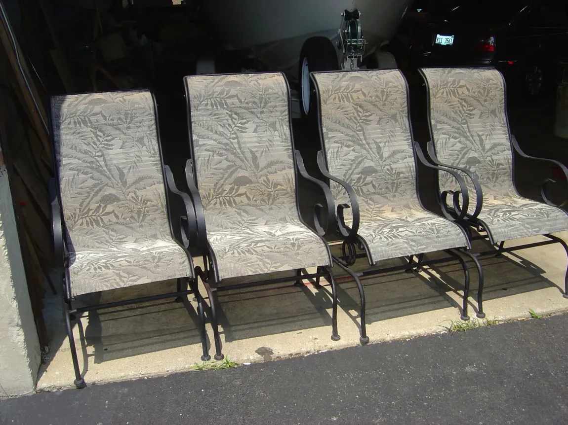 Four chairs are lined up in a row in front of a garage door