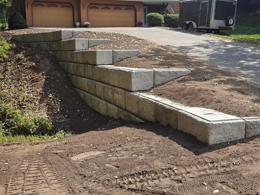 A concrete wall is being built in front of a house.
