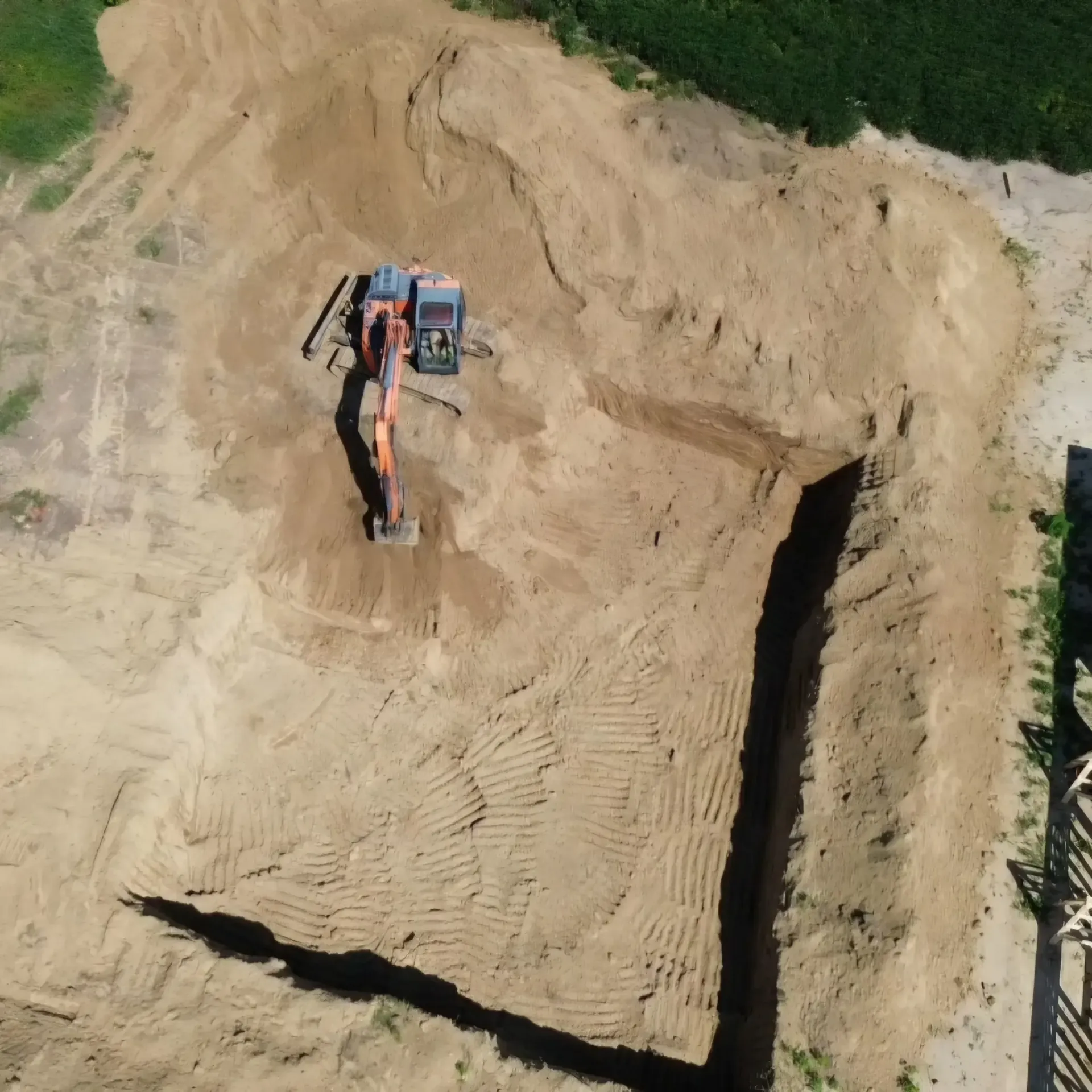 An aerial view of a construction site with a large pile of dirt